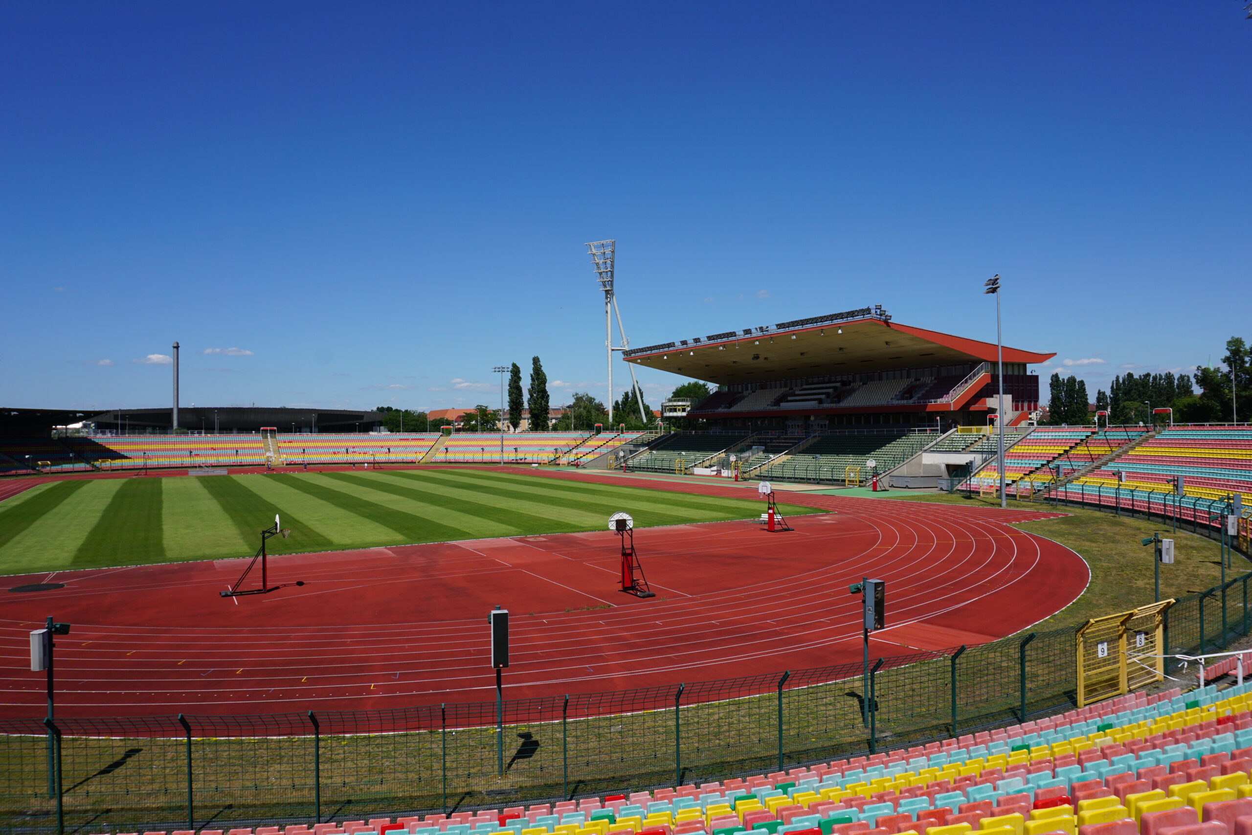 Foto zeigt die Innenansicht des Stadions im Jahnsportpark Berlin. Es ist ein Lauffeld, der großer Rasen und die Tribüne abgebildet.